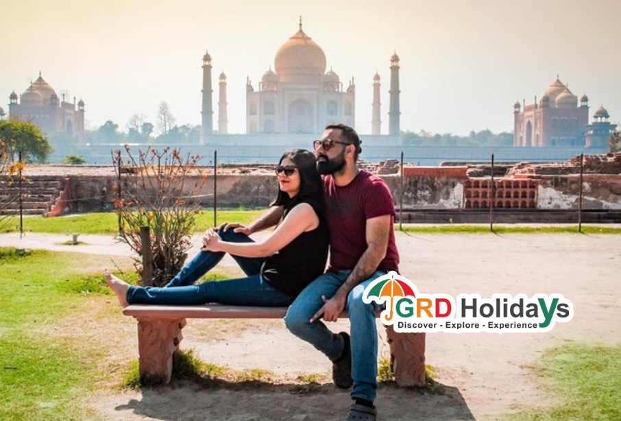 couple siting backside of taj mahal mehtab garden